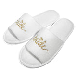Elegant white bride and bridesmaid slippers for wedding featuring a gold embroidered 'Bride' design