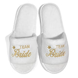 White bride and bridesmaid slippers for wedding with gold embroidery saying Team Bride
