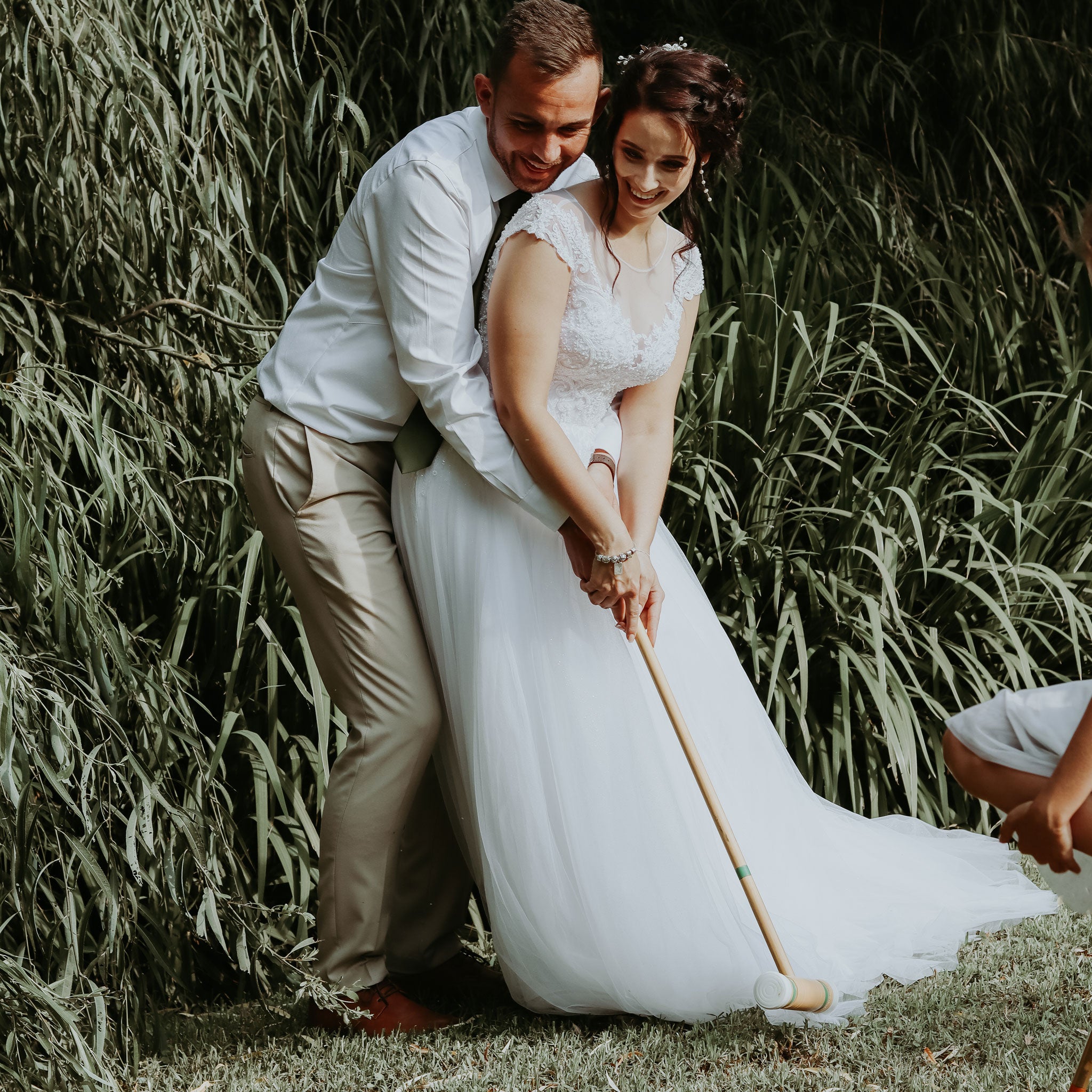 Bride and groom playing croquet outdoors using croquet rental forevermore moments in a wedding setting