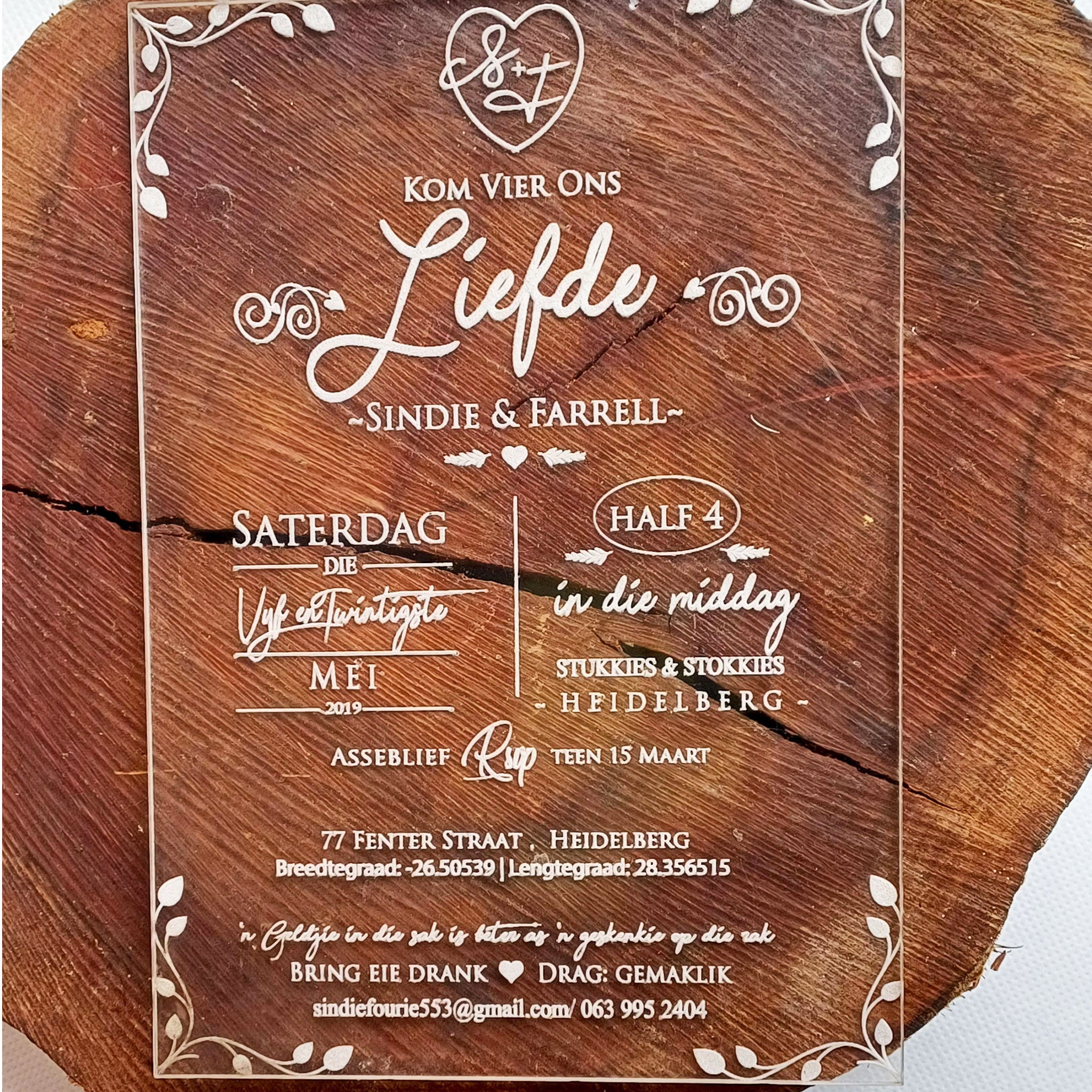 Elegant custom acrylic wedding invitations with white script text and decorative border