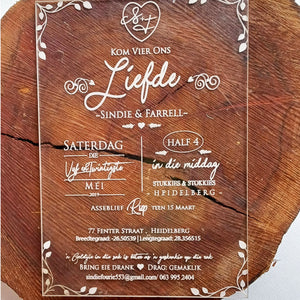 Elegant custom acrylic wedding invitations with white script text and decorative border