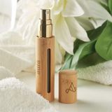 Elegant custom bridesmaid perfume bottle in bamboo with a gold spray nozzle, perfect for special occasions