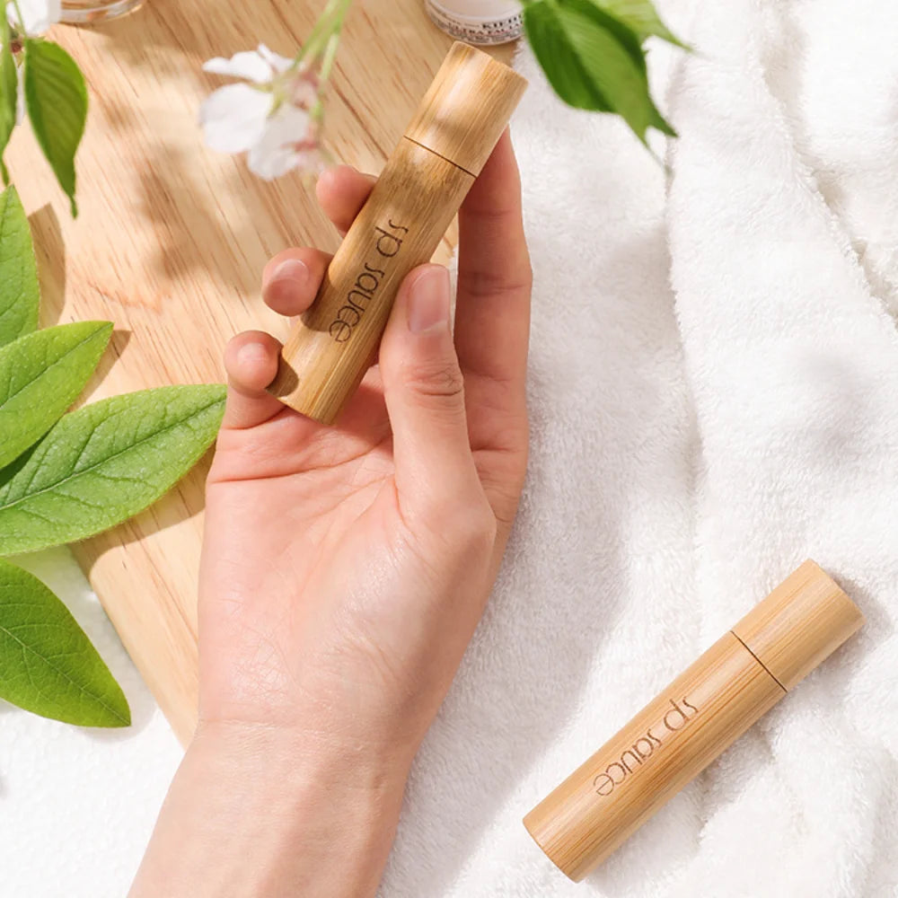 Elegant custom bridesmaid perfume bottle in bamboo design with hand for a personalized touch
