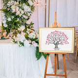 Elegant fingerprint tree wedding guestbook displayed at a beautifully decorated wedding venue