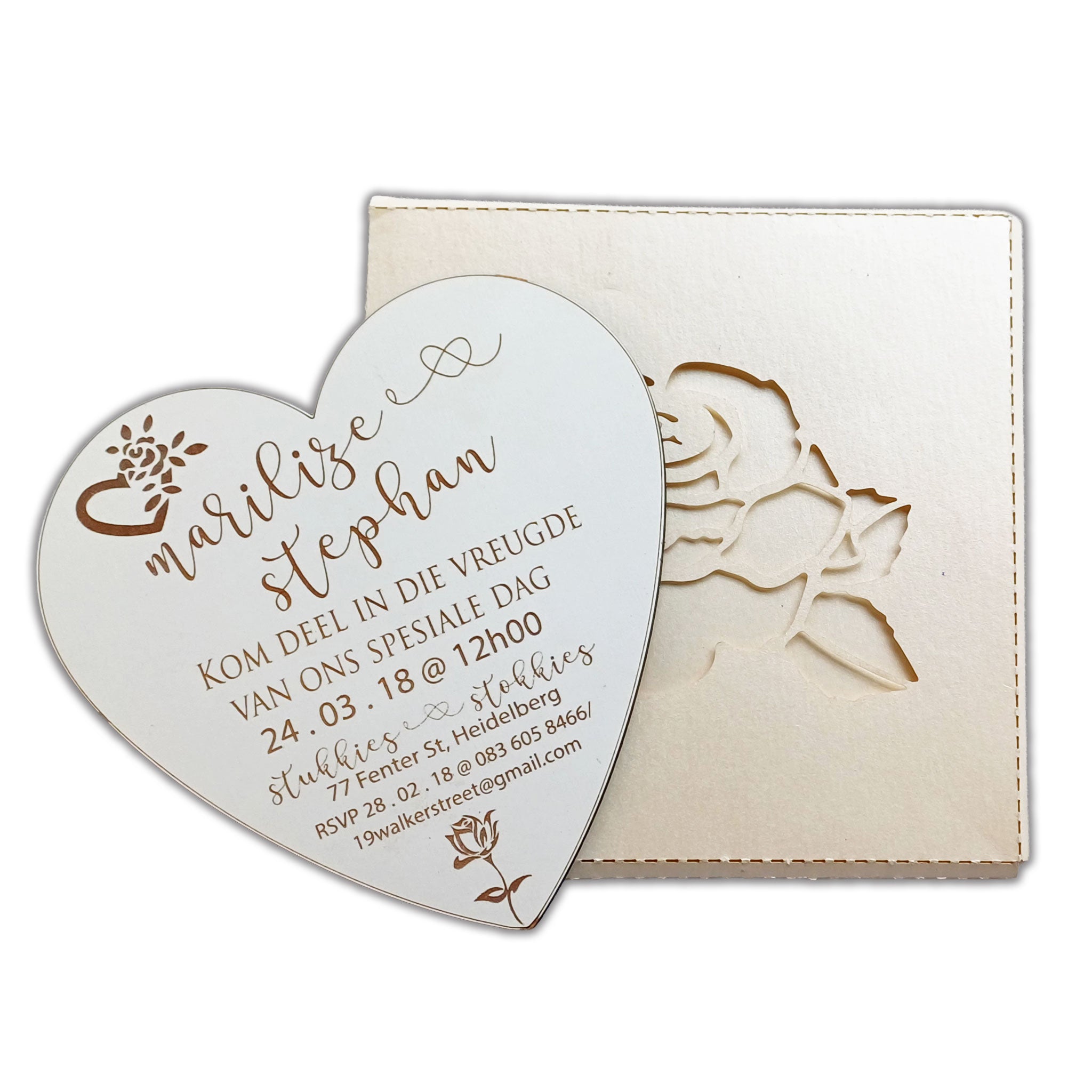 Elegant heart-shaped wedding invitation with floral design and personalized text engraved on wood
