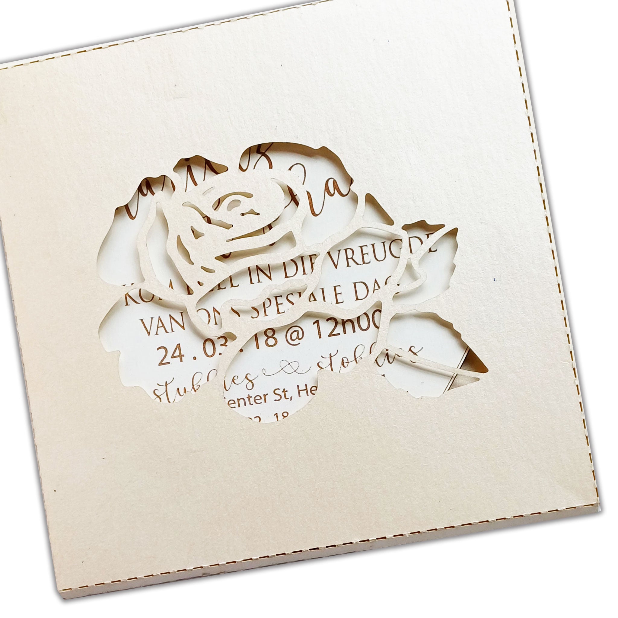 Elegant heart-shaped wedding invitation with intricate rose cutout design