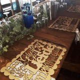 Forevermore Momentos laser-cut underplate keepsake with personalized names on wooden table centerpiece