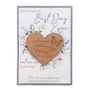 Laser-cut wooden heart magnet with save the date text and butterfly design on floral card