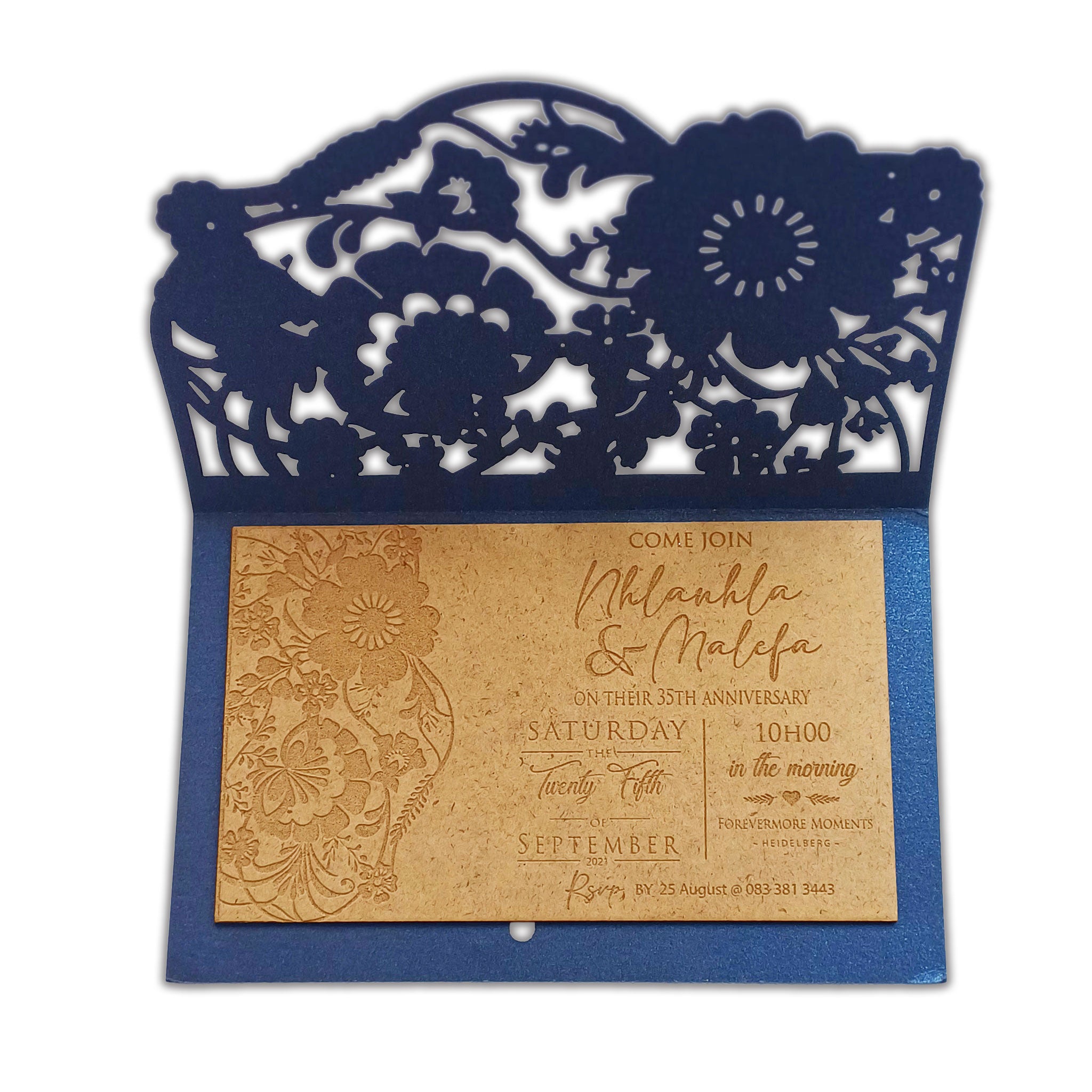 Elegant laser engraved wooden wedding invitation with floral cutout design in a navy blue envelope