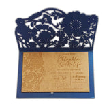 Elegant laser engraved wooden wedding invitation with floral cutout design in a navy blue envelope