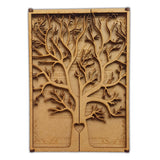 Intricate laser cut tree wedding invitation with detailed branches and heart design at the base