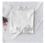 Personalized bridal party sleepwear in white with satin ribbons and a soft fabric finish