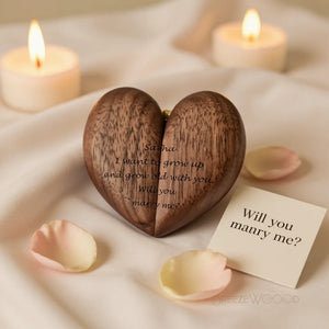 Personalized heart wood ring box with romantic wedding proposal engraving surrounded by candlelight