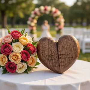 Personalized heart wood ring box by Forevermore Momentos displayed with floral bouquet at a wedding venue