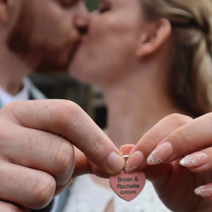 Couple holding a personalized love locks wedding heart-shaped padlock with names 