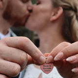 Couple holding a personalized love locks wedding heart-shaped padlock with names 