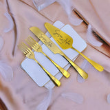 Personalized wedding cake cutting set with gold utensils featuring custom names on elegant plates