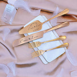 Personalized wedding cake cutting set with engraved names and date on elegant gold utensils