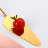 Personalized wedding cake cutting set with elegant gold server and tomato for decorative display