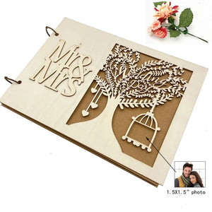 Rustic wood wedding guest book featuring a Mr and Mrs design and intricate tree details.