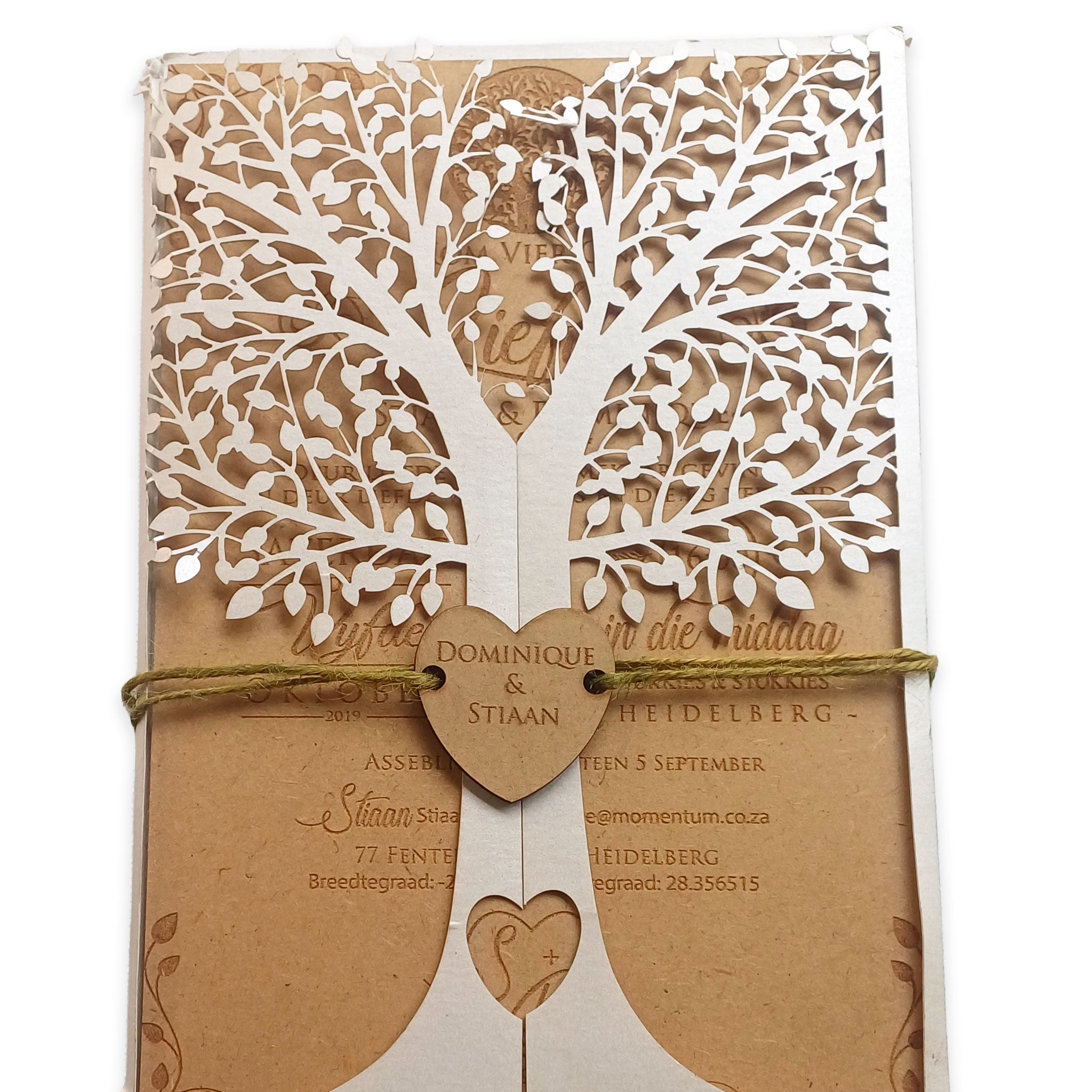 Elegant tree design wedding invites with intricate white tree cutout and rustic kraft paper background