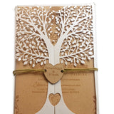 Elegant tree design wedding invites with intricate white tree cutout and rustic kraft paper background