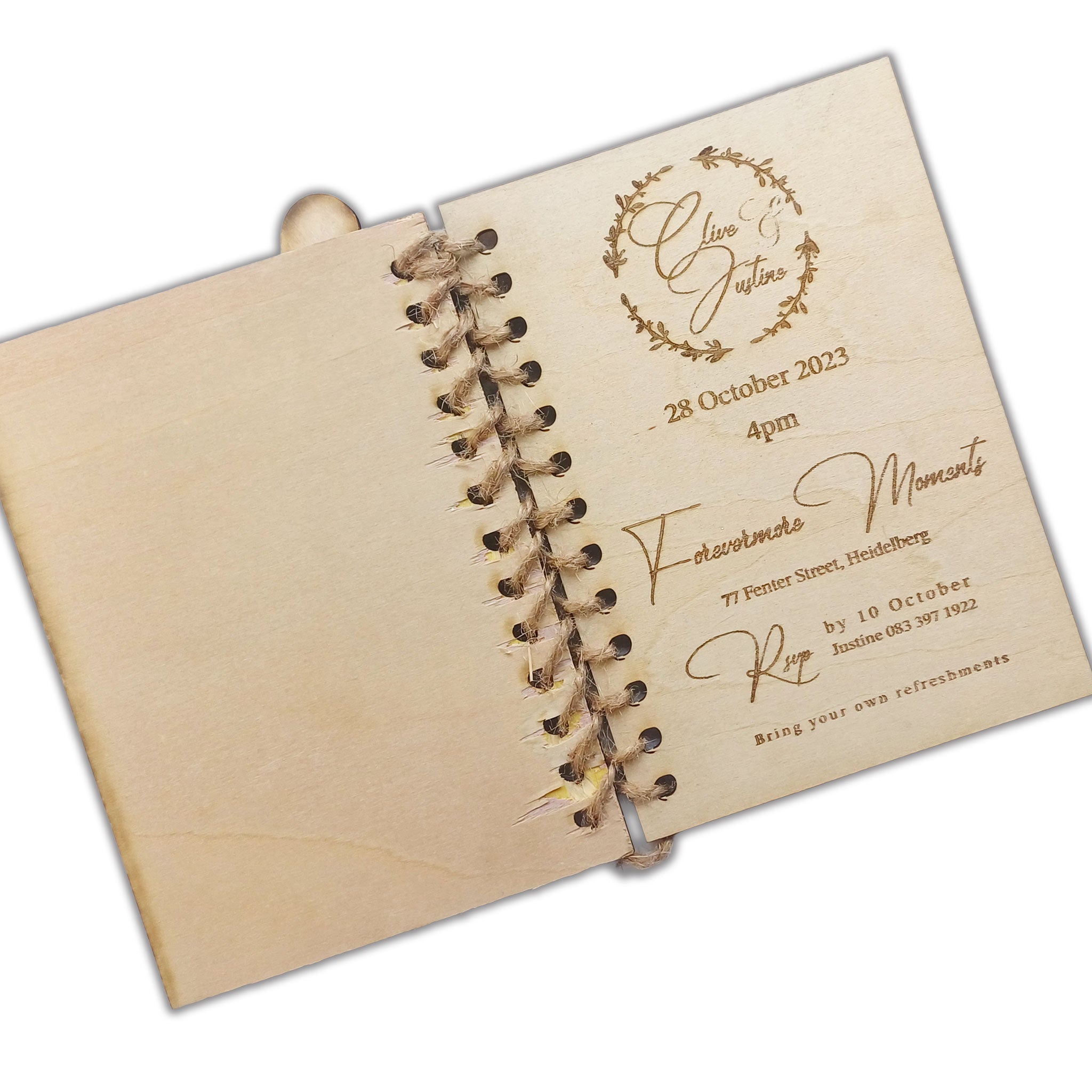 Unique book-style wedding invitations by Forevermore Momentos with rustic wooden cover and elegant engraved text