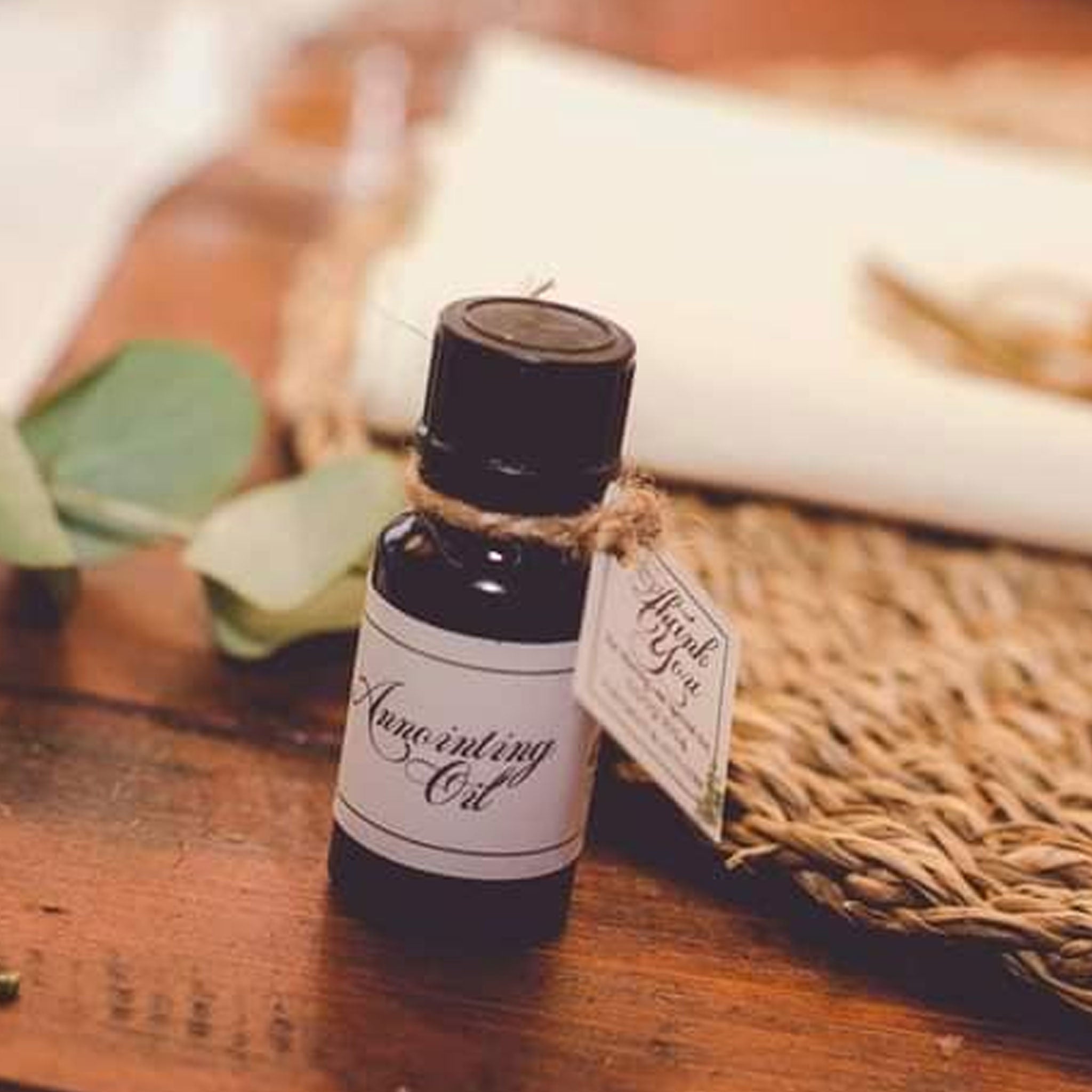 Forevermore Momentos wedding anointing oil gift bottle on wooden table with decorative leaves