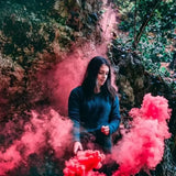 Bride using wedding party smoke bomb props for a stunning outdoor photo shoot