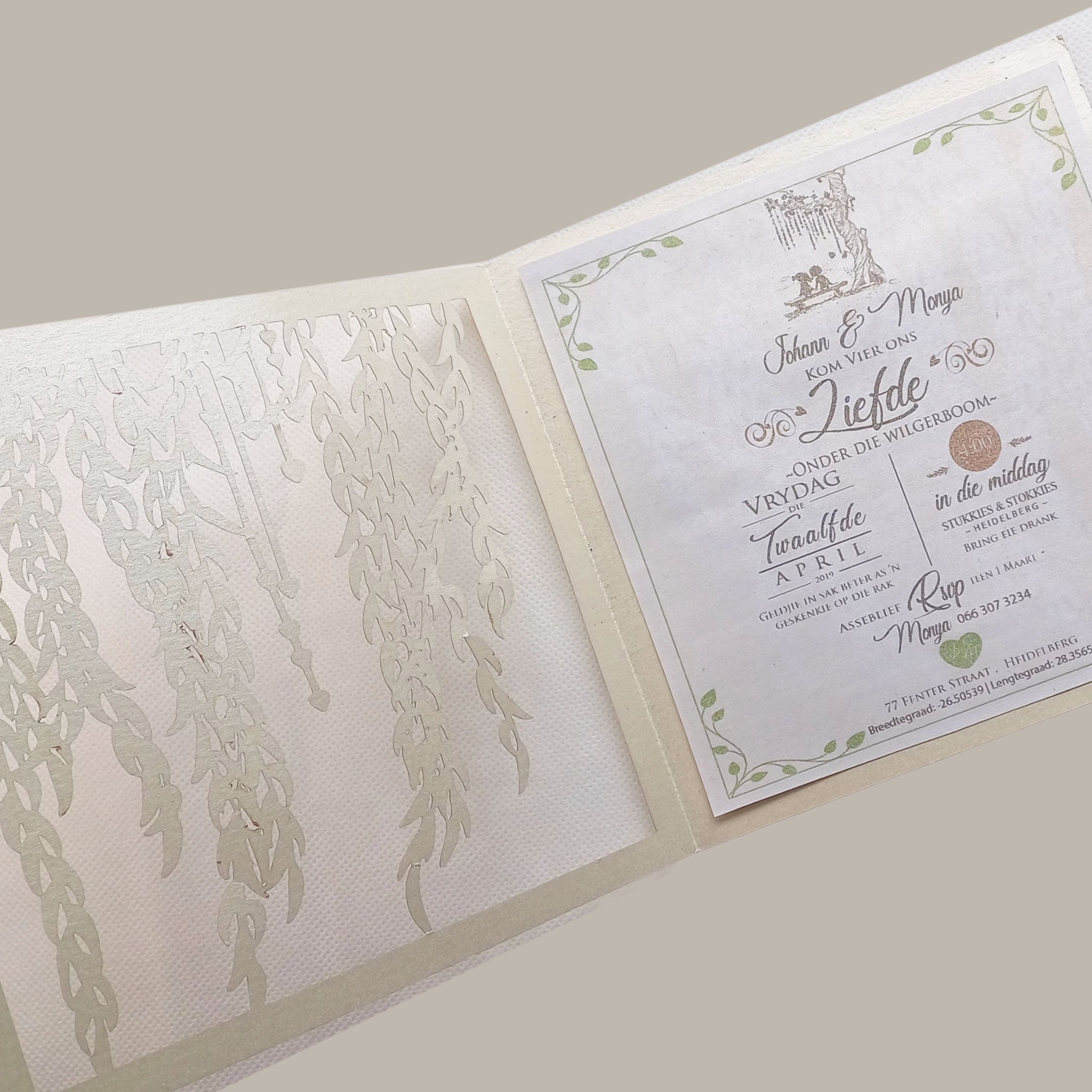 Elegant wedding invitation with delicate willow leaf invitation design in soft neutral tones