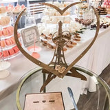 Wooden heart wedding guest book display with elegant design and dessert table background