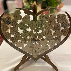 Wooden heart wedding guest book with love notes and messages from guests on decorative hearts