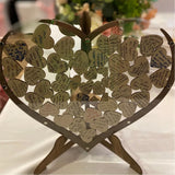 Wooden heart wedding guest book with love notes and messages from guests on decorative hearts