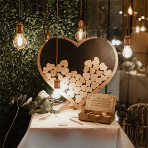 Wooden heart wedding guest book display with engraved messages and heart-shaped wooden pieces