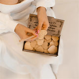 Wooden heart wedding guest book with heart-shaped cards for guests to leave messages at the wedding