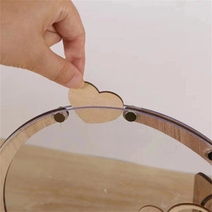 Person placing a wooden heart in a wooden heart wedding guest book for wedding memories