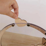 Person placing a wooden heart in a wooden heart wedding guest book for wedding memories