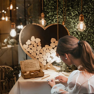 Elegant wooden heart wedding guest book with guests signing heart-shaped wooden pieces
